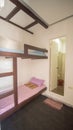 Budget room in a youth hostel in Asia on two beds. Royalty Free Stock Photo
