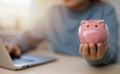 Budget and Saving money concept for financial accounting,Woman hand putting coin in piggy bank Royalty Free Stock Photo