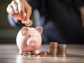 Budget and Saving Money Concept for Financial Accounting: Woman Hand Putting Coin in Piggy Bank