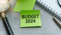 Budget 2024. top view of an open notebook with text. glasses near the notebook.close-up