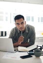 Budget well so you can live well. Portrait of a young man using a laptop while going through paperwork in the kitchen at Royalty Free Stock Photo