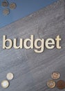 Budget 2023 on wood and blue background, British coins and notes Royalty Free Stock Photo