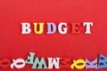 BUDGET word on red background composed from colorful abc alphabet block wooden letters, copy space for ad text. Learning english Royalty Free Stock Photo