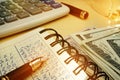 Budgeting money. Book with calculations, calculator and dollars. Royalty Free Stock Photo