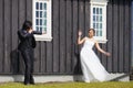 Unidentified bride and groom posing in front of Famous black church,Iceland.