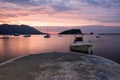 Budva bay sunrise. Panoramic view of marina, boats and old city. Royalty Free Stock Photo