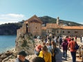 Tourist group discovering the beauty of Old Town and taking photos.in Budva in Montenegro