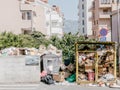 Budva, Montenegro - 05 august 2023: Overflowing trash cans next to high-rise buildings
