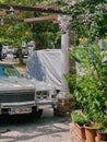 Budva, Montenegro - 08 august 2023: Vintage Cadillac stands near a pergola column in a green garden