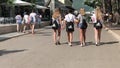 BUDVA, MONTENEGRO - AUGUST 2, 2018. Young women walk with black Nike and Adidas backsacks along the street