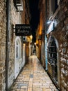 Budva, Montenegro - 25 december 2022: Signboard on a narrow street with stone houses. Caption: Old Town Bakery