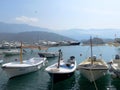 Budva / Montenegro - July 21, 2014: Fishing boats and white motor yachts are moored on the water at the pier of the city of Budva Royalty Free Stock Photo