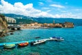 Pontoon dock with scooters on background of beach and old city walls fortress. Budva Old Town. Montenegro