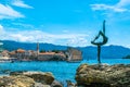 Sculpture of Dancer Statue of Gymnast or Ballerina on background of old city walls fortress. Budva Old Town. Montenegro