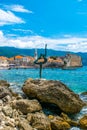 Sculpture of Dancer Statue of Gymnast or Ballerina on background of old city walls fortress. Budva Old Town. Montenegro