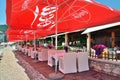 Budva, Montenegro - June 13.2019. Cafe beach in the resort area with red umbrellas with Coca Cola brand