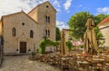 Picturesque square with a restaurant and the Holy Trinity church in the Old town in Budva Montenegro in the Balkans Royalty Free Stock Photo
