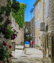 Picturesque streets of Old town Budva with a view of the Adriatic sea and bokeh flowers in the foreground in Montenegro Royalty Free Stock Photo