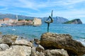 Sculpture Ballerina Dancer from Budva on background of Old Town and Island of Sveti Nikola, Budva, Montenegro