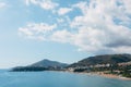 Budvan coast in Montenegro. Coastline of the cities of Rafaelovici and Beechichi. Long beach with sunbeds and umbrellas