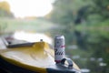 Budweiser Bud beer can on yellow kayak outdoors in the river and green trees blurred background Royalty Free Stock Photo
