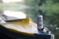 Budweiser Bud beer can on yellow kayak outdoors in the river and green trees blurred background Royalty Free Stock Photo