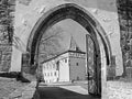 Budyne nad Ohri, Czech republic - April 07, 2018: entrance gate leading to Vodni hrad castle at beginning spring with black and w Royalty Free Stock Photo