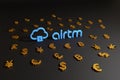 Buenos Aires, Argentina - February 19, 2021: Airtm logo surrounded many coin symbols on a black background