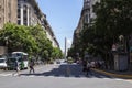 Pedestrians Crossing The Street in President Roque Saenz Pena Avenue Overlooking The Famous and Touristic Obelisk in 9 de Julio