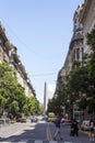 Pedestrians Crossing The Street in President Roque Saenz Pena Avenue Overlooking The Famous and Touristic Obelisk in 9 de Julio