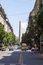 Pedestrians Crossing The Street in President Roque Saenz Pena Avenue Overlooking The Famous and Touristic Obelisk in 9 de Julio