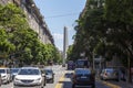 Pedestrians Crossing The Street in President Roque Saenz Pena Avenue Overlooking The Famous and Touristic Obelisk in 9 de Julio