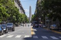 Pedestrians Crossing The Street in President Roque Saenz Pena Avenue Overlooking The Famous and Touristic Obelisk in 9 de Julio