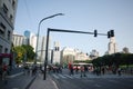 People cross road on pedestrian crossing in city center near entrance to Retiro metro station Royalty Free Stock Photo