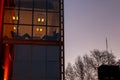 Pair of men relaxing on couches near a dark window in an office in Puerto Madero, Buenos Aires