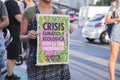 Unrecognizable woman holding a poster poster to warn about the climate crisis