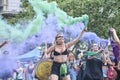 Women waving green and violet smoke flares in the air during 8M feminist strike