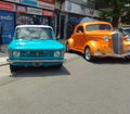 Fiat 128 sedan 1970s beside a Chevy Master 1930s. Expo Warnes 2021 classic car show. Copyspace