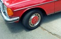 Logo on wheel cup of a red German Mercedes Benz W123. Expo Warnes 2021 classic car show. Royalty Free Stock Photo