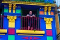 BUENOS AIRES / ARGENTINA - 05/04/2019: Old man on the colorful blue balcony in a old building in Caminito, Argentina