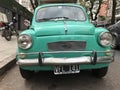 Old azure colored turquoise Fiat parked on the street in Buenos Aires, Argentina