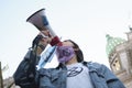 Young female activist using a megaphone to speak about the climate emergency