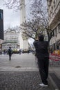 Tourist taking a picture of the Obelisk of the city of Buenos Aires. Argentina