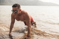 A buff asian man wearing shades does pushups at the beach. Chest workout or calisthenics outdoors Royalty Free Stock Photo