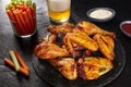 Buffalo chicken wings with cheese and barbecue sauces and celery and carrot sticks, with a glass of beer Royalty Free Stock Photo