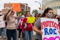 Woman marching with 'Protect Roe' at justice rally