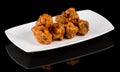 BUFFALO WINGS  on black background with reflection Royalty Free Stock Photo