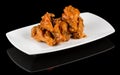 BUFFALO WINGS  on black background with reflection Royalty Free Stock Photo