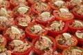 Buffet appetizer: tomatoes stuffed with canned tuna and onions, garnished with a slice of lemon