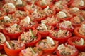 Buffet appetizer: tomatoes stuffed with canned tuna and onions, garnished with a slice of lemon